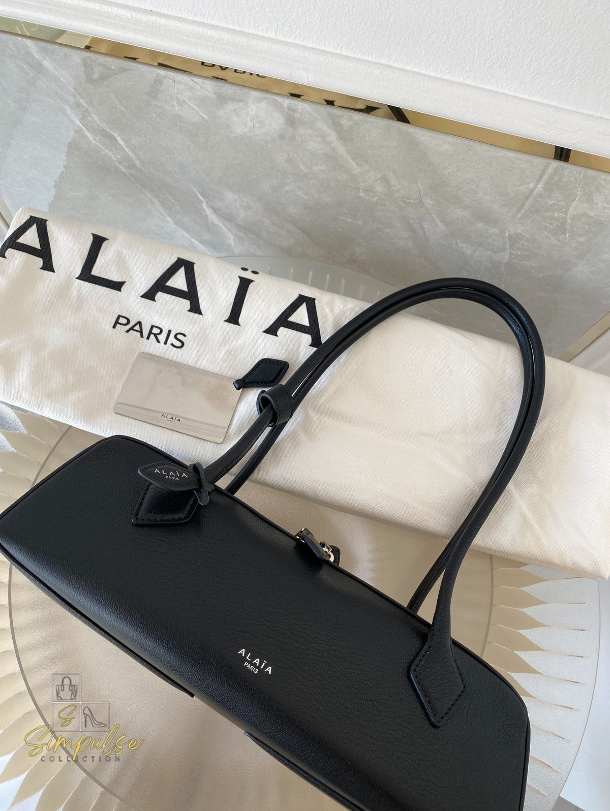 ALAIA LE TECKEL MEDIUM BAG IN GOATSKIN IN BLACK